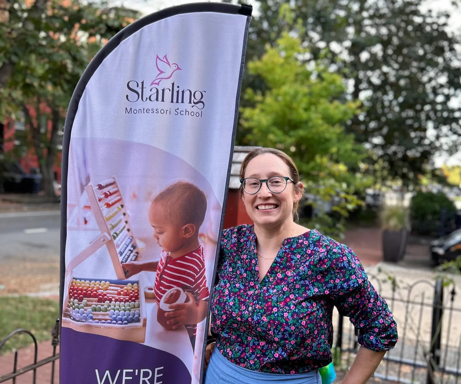 Fabienne Deaton, founder of Starling Montessori, photographed beside the school's banner on Capitol Hill